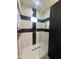 Walk-in shower with black and white hexagon tile and glass enclosure at 4237 E 4Th Ave, Apache Junction, AZ 85119