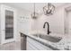 Modern kitchen features granite countertops, stainless steel sink, and pendant lighting at 44033 W Palo Olmo Rd, Maricopa, AZ 85138