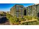Aerial view of a modern apartment building complex with a green lawn at 7120 E Kierland Blvd # 416, Scottsdale, AZ 85254