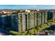 Aerial view of a modern apartment building with lush landscaping and city views at 7120 E Kierland Blvd # 416, Scottsdale, AZ 85254