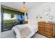 Bright bedroom with balcony access and wood dresser at 7120 E Kierland Blvd # 416, Scottsdale, AZ 85254