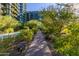 Landscaped walkway with benches, leading through a lush garden at 7120 E Kierland Blvd # 416, Scottsdale, AZ 85254