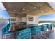 L-shaped outdoor kitchen with bar seating and TVs at 7120 E Kierland Blvd # 416, Scottsdale, AZ 85254