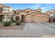 Two-story house with three-car garage and desert landscaping at 10439 W Cashman Dr, Peoria, AZ 85383