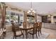 Formal dining room with a wood table and chandelier at 12844 W El Sueno Dr, Sun City West, AZ 85375