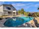 Two-story house with a kidney-shaped pool and grassy backyard at 1328 E Cottonwood Ln, Phoenix, AZ 85048