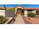 Spanish style home with red tile roof, double doors, and landscaped walkway at 14510 W White Rock Dr, Sun City West, AZ 85375