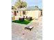 Landscaped backyard with artificial turf and seating area at 2143 W Wilshire Dr, Phoenix, AZ 85009