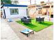 Private backyard with artificial turf, pergola, and seating area at 2143 W Wilshire Dr, Phoenix, AZ 85009