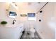 Clean bathroom with a white vanity, black accents and patterned floor at 2143 W Wilshire Dr, Phoenix, AZ 85009