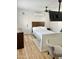 Bright bedroom with a queen-size bed and built-in shelving at 2143 W Wilshire Dr, Phoenix, AZ 85009