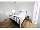 Bright bedroom with a metal bed frame and light wood flooring at 2143 W Wilshire Dr, Phoenix, AZ 85009