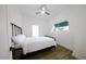 Bright bedroom with a double bed, ceiling fan, and large window at 2143 W Wilshire Dr, Phoenix, AZ 85009