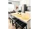 Kitchen with an island and four barstools at 2143 W Wilshire Dr, Phoenix, AZ 85009