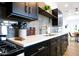 Modern kitchen featuring dark cabinetry, white countertops, and gray tile backsplash at 2143 W Wilshire Dr, Phoenix, AZ 85009