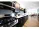 Sleek kitchen with stainless steel appliances and dark cabinetry at 2143 W Wilshire Dr, Phoenix, AZ 85009