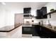 Modern kitchen with dark cabinetry and stainless steel appliances at 2143 W Wilshire Dr, Phoenix, AZ 85009
