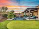 Stunning backyard with pool, spa, putting green, and covered patio at 32388 N 129Th Dr, Peoria, AZ 85383