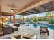 Relaxing covered patio with comfortable seating overlooking the pool at 32388 N 129Th Dr, Peoria, AZ 85383