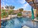 Inviting pool and spa area with a waterfall feature and lush landscaping at 32388 N 129Th Dr, Peoria, AZ 85383