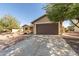 Single-story home with a two-car garage and desert landscaping at 3671 N Monument Dr, Florence, AZ 85132