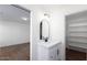 Bathroom with white vanity, black fixtures, and built-in shelving at 3830 N Kioha Dr, Eloy, AZ 85131