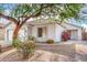 House with tree-lined front yard and drought-tolerant landscaping at 9173 W Salter Dr, Peoria, AZ 85382