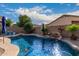 Relaxing freeform pool with a waterfall and plenty of sunshine at 9173 W Salter Dr, Peoria, AZ 85382