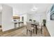 Dining area adjacent to the kitchen featuring a table, chairs, and modern light fixture at 9273 W Sheridan St, Phoenix, AZ 85037