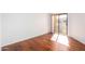 Bright bedroom featuring hardwood floors and sliding glass door to balcony at 11640 N 51St Ave # 250, Glendale, AZ 85304