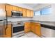 Kitchen with stainless steel appliances and wood cabinets at 11640 N 51St Ave # 250, Glendale, AZ 85304
