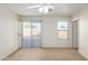 Bedroom with sliding glass door, window, and carpet at 15872 W Evans Dr, Surprise, AZ 85379