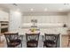 Modern kitchen with white cabinets, quartz countertops and island at 17243 W Seldon Ln, Waddell, AZ 85355