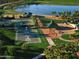 Aerial view of community amenities including lake, sports courts, and playground at 18096 W Hiddenview Dr, Goodyear, AZ 85338