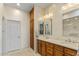 Double vanity bathroom with wood cabinets and marble countertops at 19475 N Grayhawk Dr # 1115, Scottsdale, AZ 85255