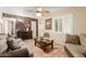 Cozy living room featuring stone accent wall, ceiling fan, and comfortable seating at 2746 W Turney Ave, Phoenix, AZ 85017