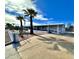 Side view of a manufactured home with a ramp and fenced yard at 394 N Pinyon Dr, Apache Junction, AZ 85120