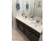 Double vanity bathroom with dark brown cabinets and tiled floor at 4040 E Caitlin Dr, San Tan Valley, AZ 85140