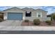 Single-story home with a two-car garage and well-manicured landscaping at 4040 E Caitlin Dr, San Tan Valley, AZ 85140