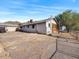 Rear view of house, with gravel parking area at 47 N Stansberry Ave, Superior, AZ 85173