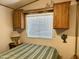 Cozy bedroom with striped bedding, built-in cabinets, and window coverings at 7750 E Broadway Rd # 149, Mesa, AZ 85208