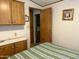 Bedroom with wood cabinets, access to bathroom, and striped bedding at 7750 E Broadway Rd # 149, Mesa, AZ 85208