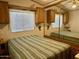 Main bedroom with mirrored closet doors and striped bedding at 7750 E Broadway Rd # 149, Mesa, AZ 85208