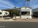 Mobile home exterior with covered porch and small tree at 7750 E Broadway Rd # 149, Mesa, AZ 85208