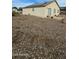 Large backyard with gravel and some desert landscaping at 12459 W Benito Dr, Arizona City, AZ 85123