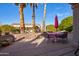 Covered patio with seating and a red umbrella at 16316 W Willow Creek Ln, Surprise, AZ 85374