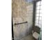 Bathroom with granite shower, grab bar and large window at 20707 N Ventana W Dr, Sun City, AZ 85373