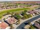 Aerial view of a house situated near a golf course and residential area at 2596 E Desert Wind Dr, Casa Grande, AZ 85194