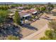 Aerial view of a community of houses with desert landscaping and a golf course at 2596 E Desert Wind Dr, Casa Grande, AZ 85194