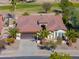 Single-story home with brown roof, desert landscaping, and golf course views at 2596 E Desert Wind Dr, Casa Grande, AZ 85194